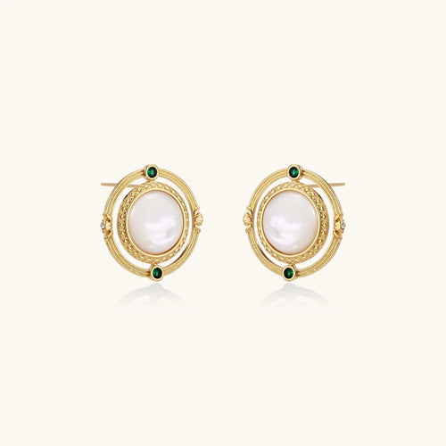 Circular gold stud earrings with iridescent mother-of-pearl center and green zirconia accents on cream background.